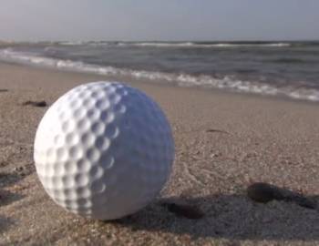 Golf ball on beach