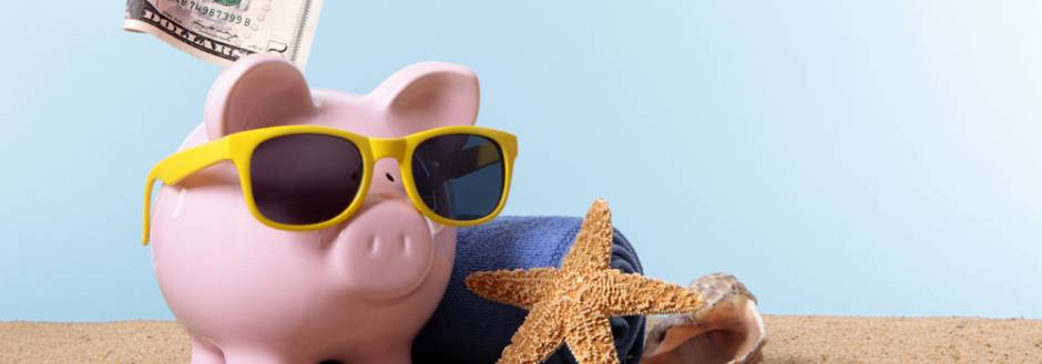Piggy Bank with sunglasses on the beach 