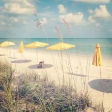 Beach with yellow umbrellas and chairs