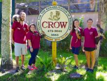 C.R.O.W. staff in front of sign